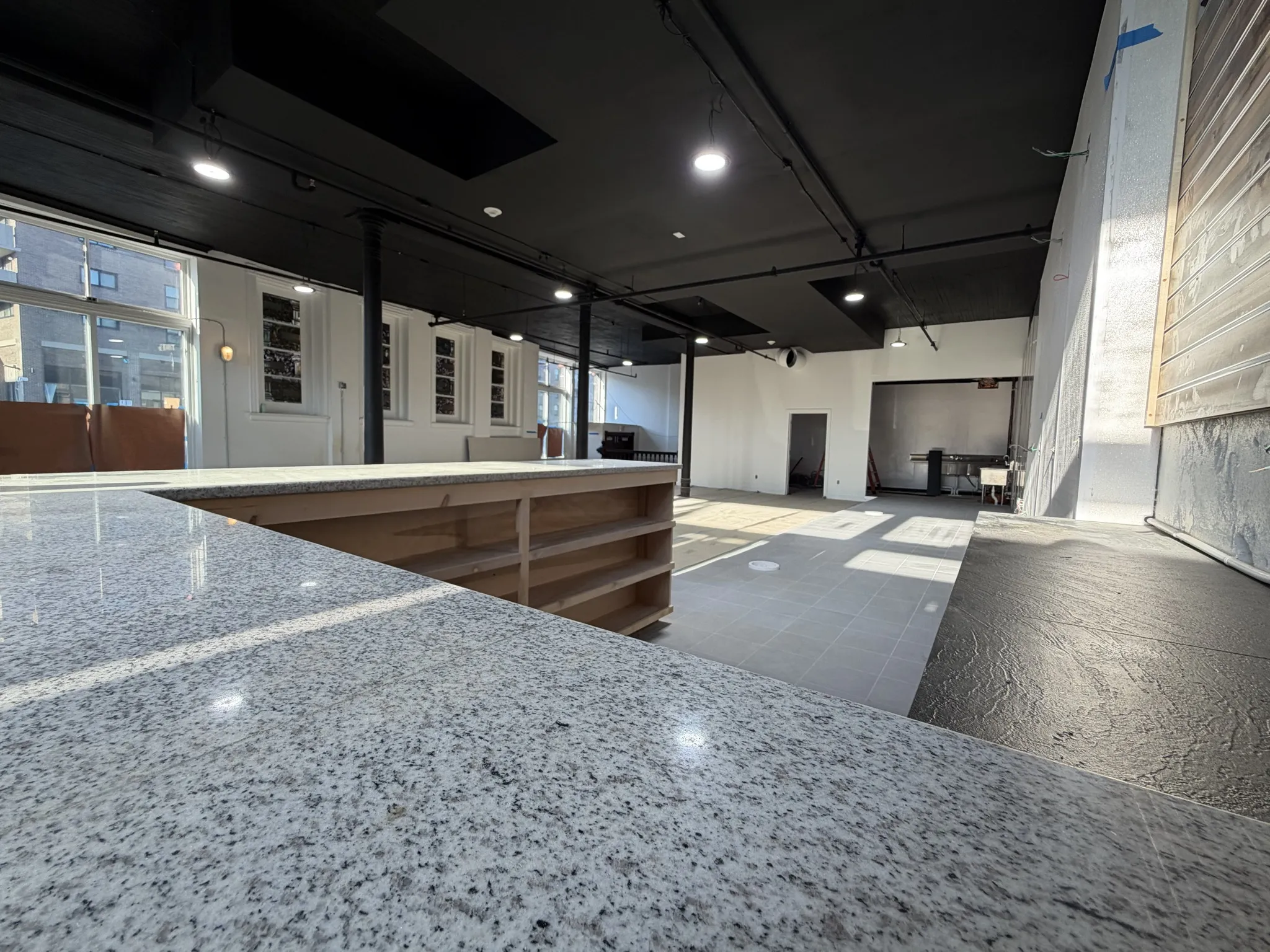 Granite bar counter in commercial buildout with tiled dining area