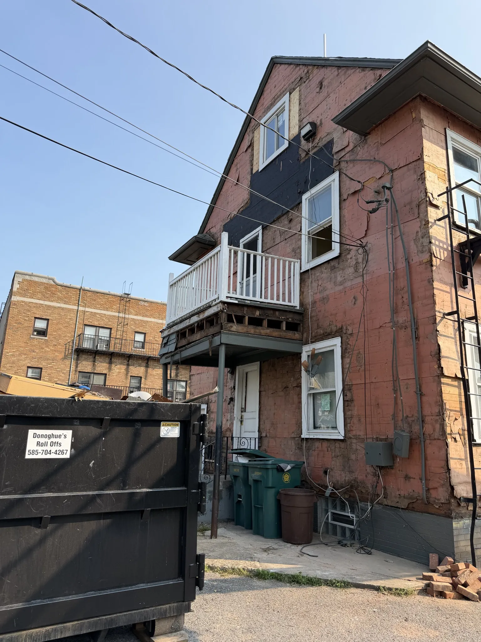 House exterior with siding stripped down to sheathing during renovation