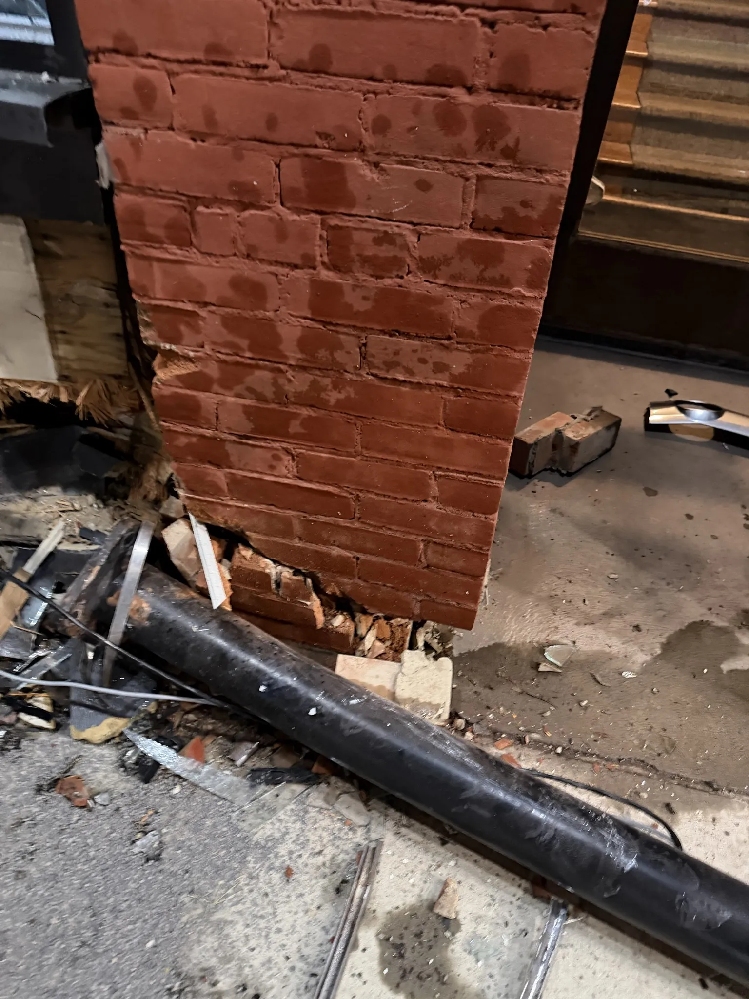 Cracked brick support column exposed after structural damage